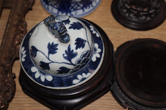 A large blue and white Chinese and a smaller similar vase with wooden cover, two stands and a cover